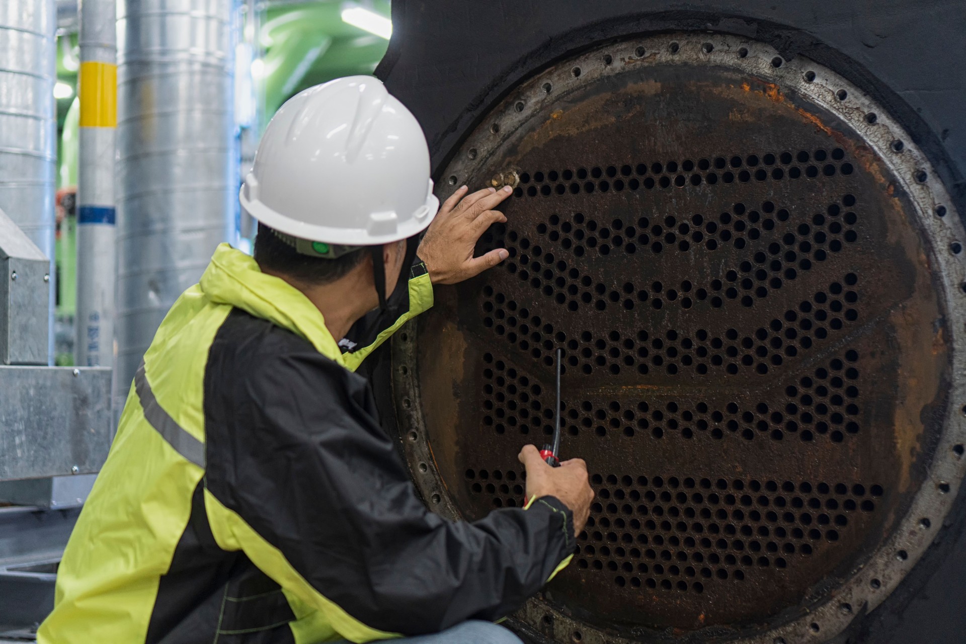 Worker work with  shell tube evaporator on Chiller Plant